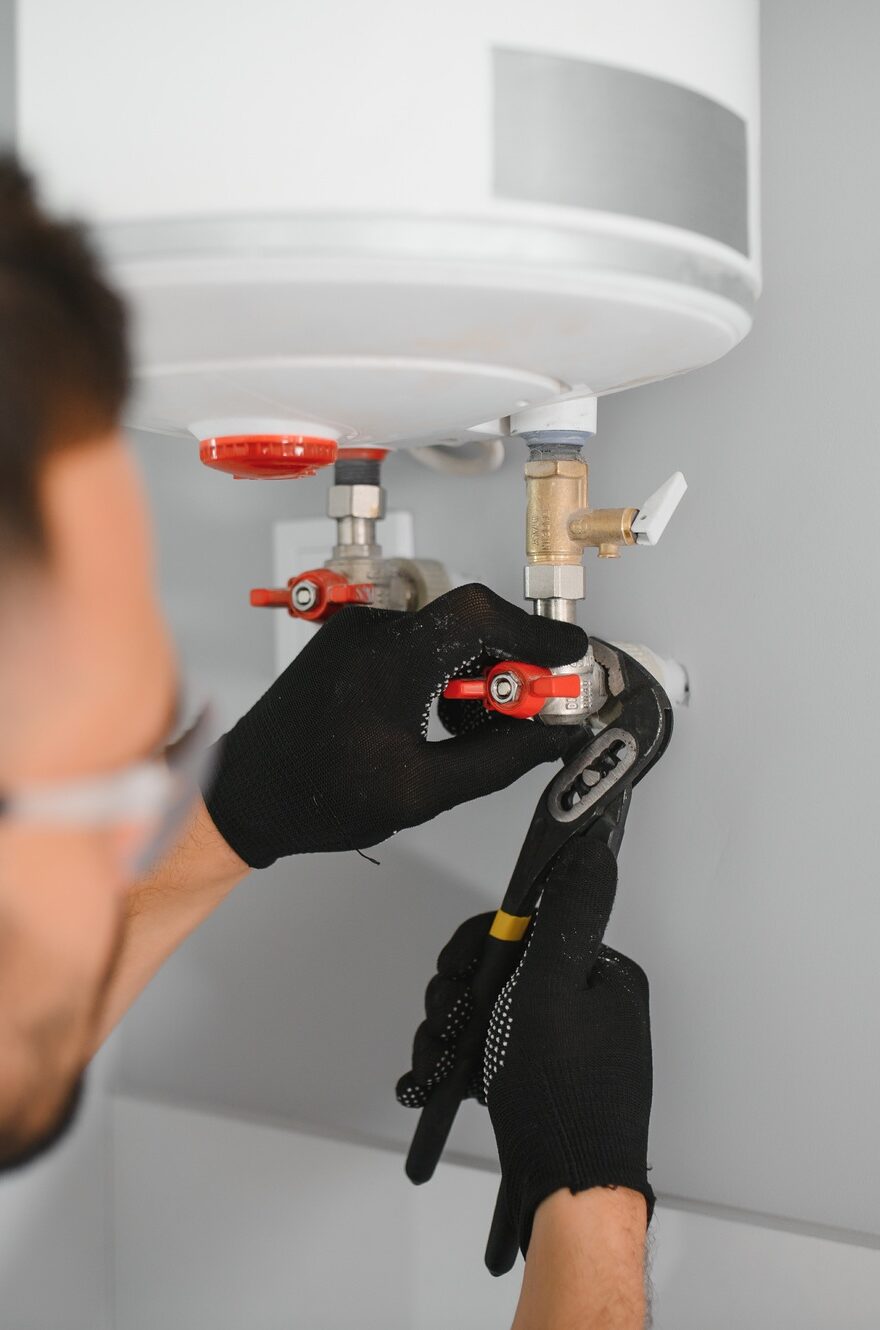 Professional plumber servicing a boiler